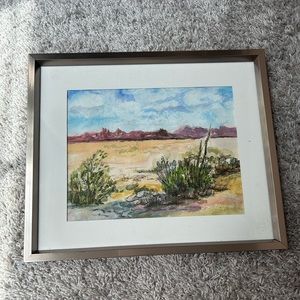 Desert scene drawing. Silver metal frame.